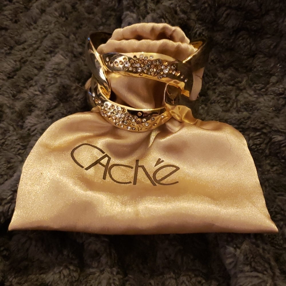 Cache gold colored bangle with crystals.